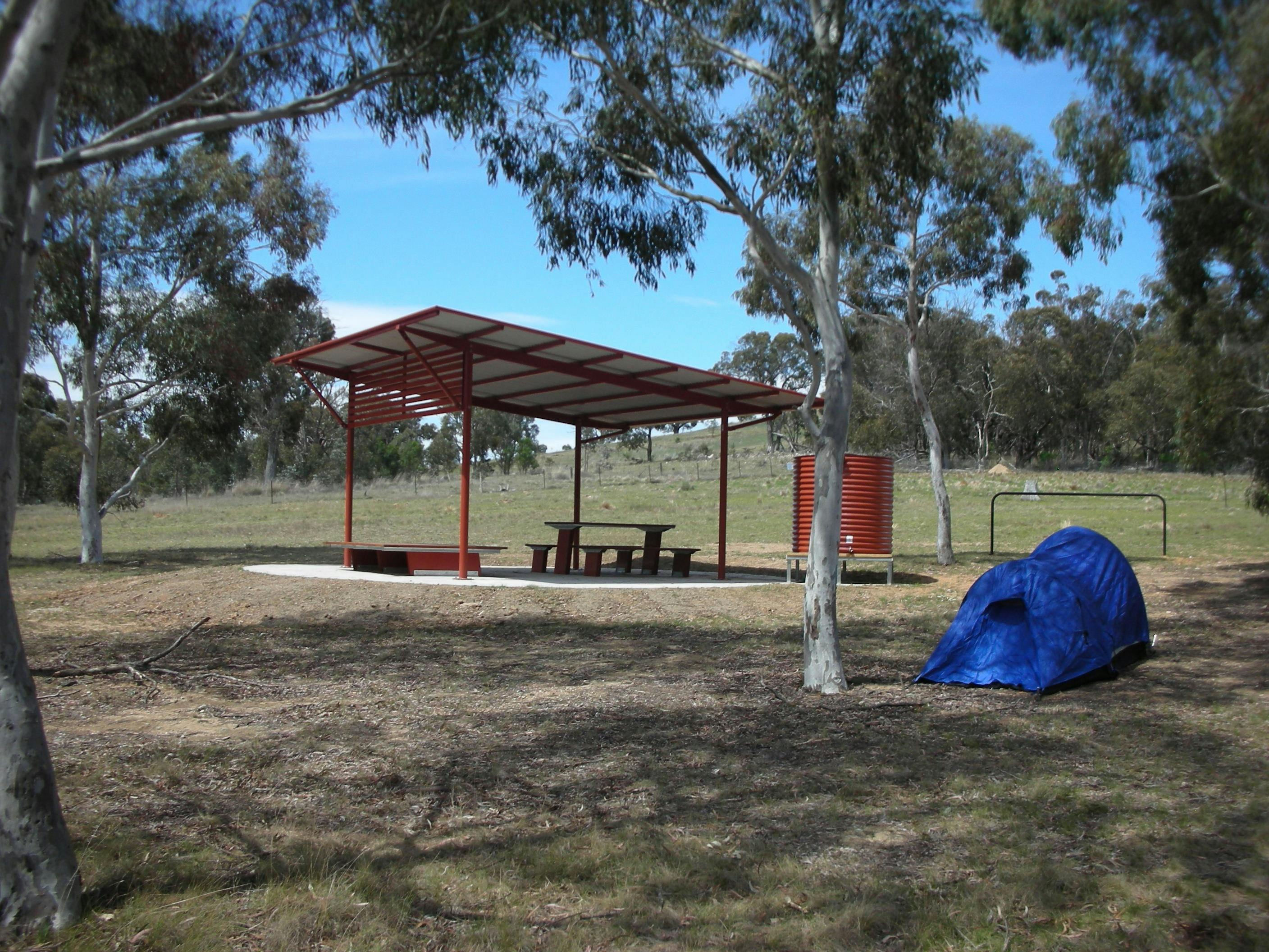 Structure in background with small tent in foreground