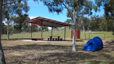 Structure in background with small tent in foreground