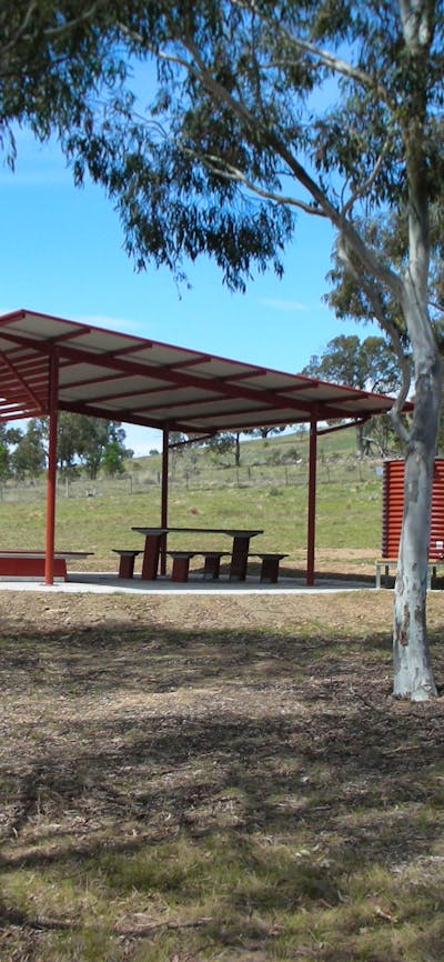 Structure in background with small tent in foreground