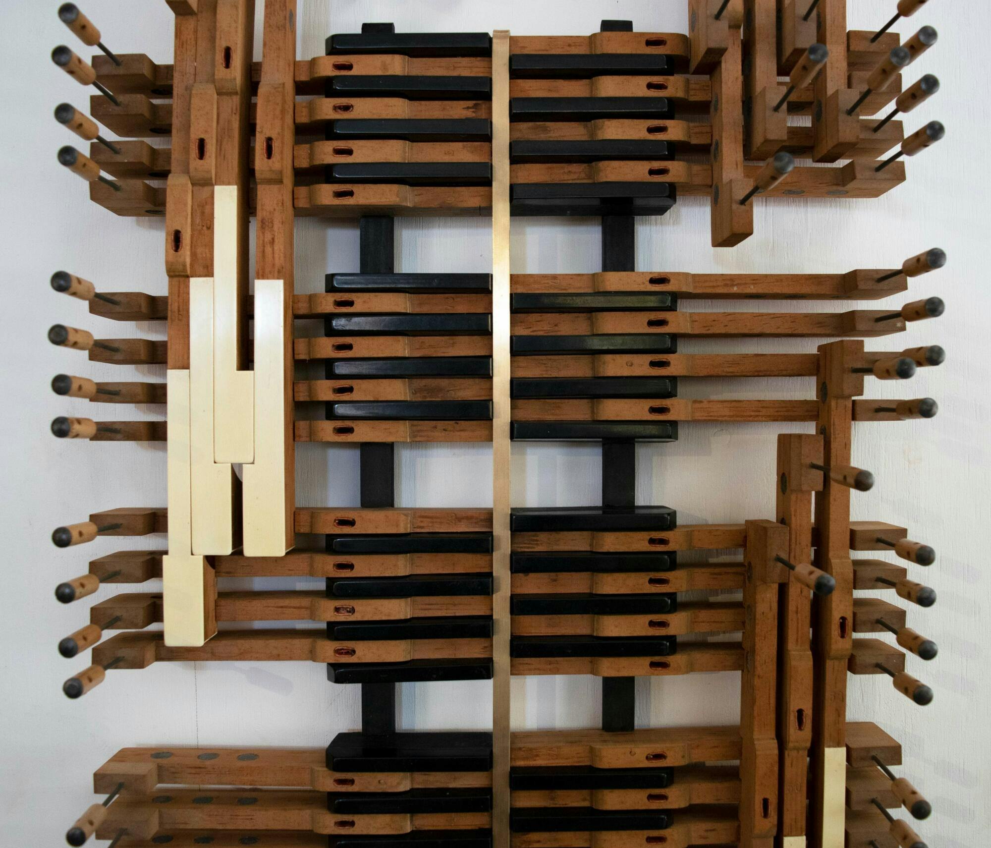 wall mounted sculpture assembled using piano keys (wooden and white)