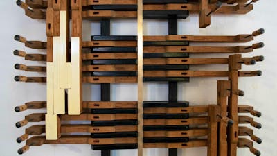 wall mounted sculpture assembled using piano keys (wooden and white)