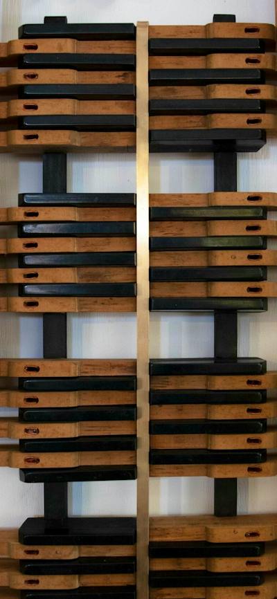 wall mounted sculpture assembled using piano keys (wooden and white)