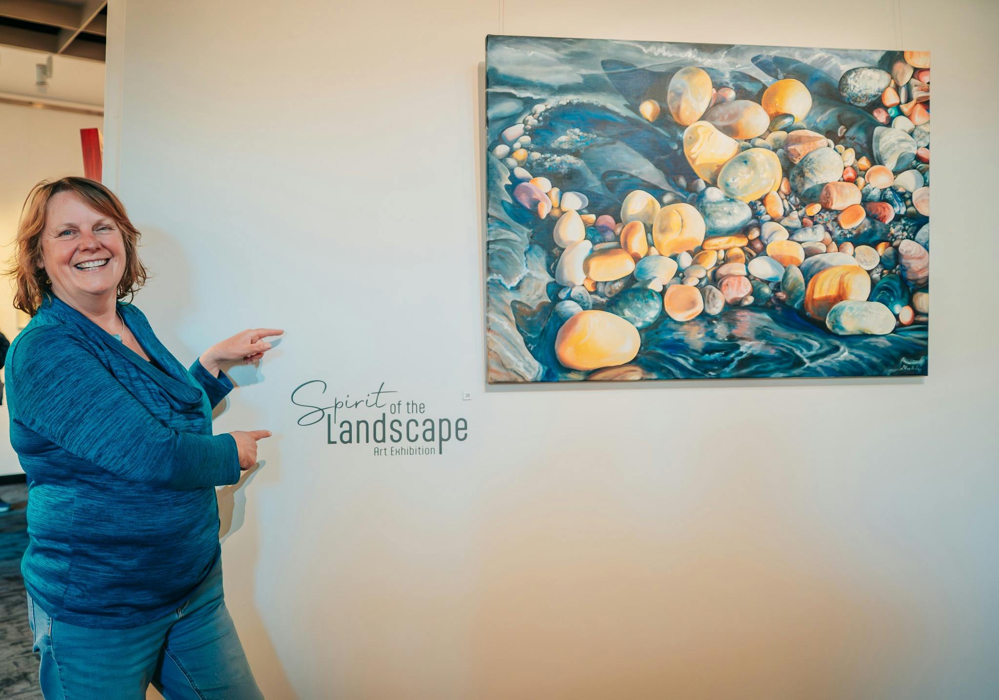 Artist Linda MacAulay(VIC) at Spirit of the Landscape Exhibition next to her painting