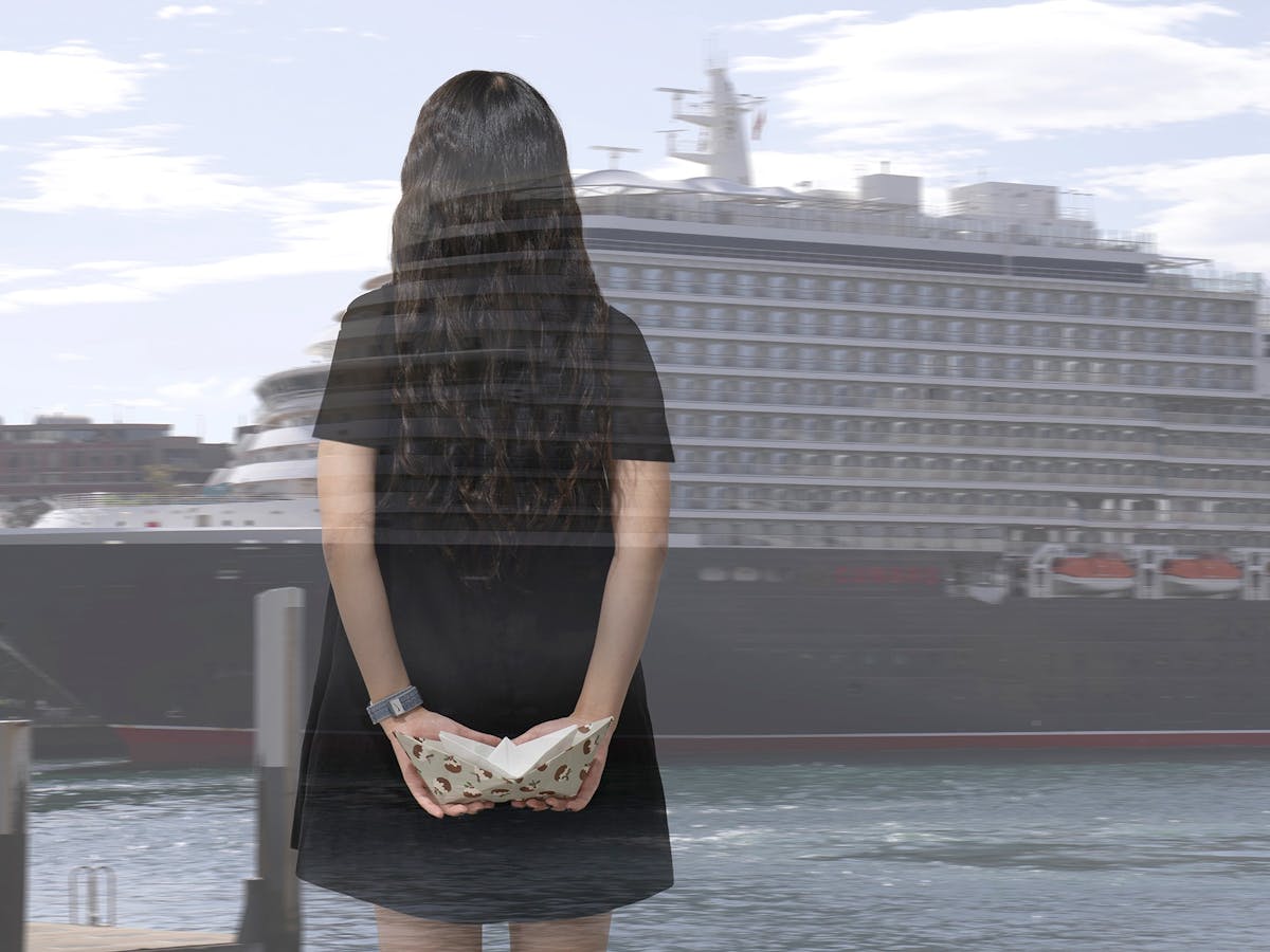 A transparent image of the back of a woman with long dark hair is superimposed against a cruise shi