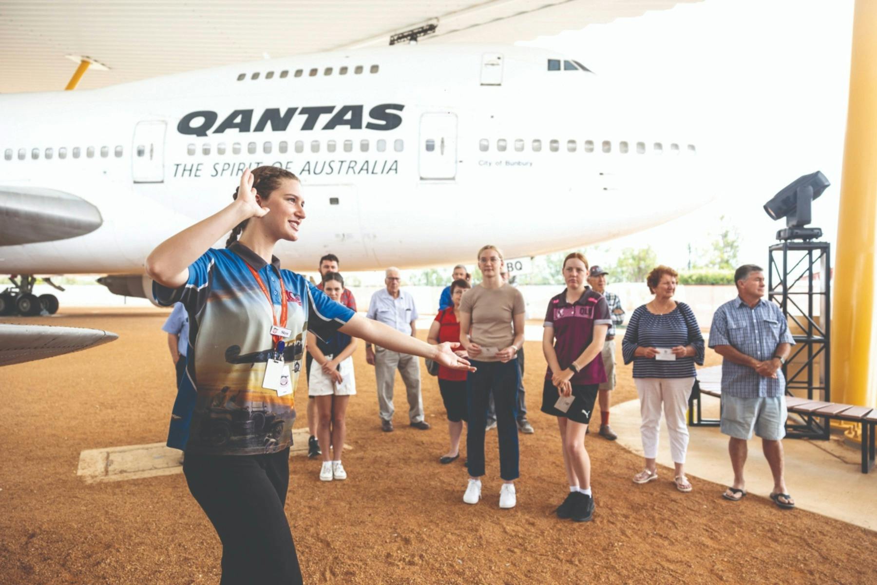 a guide showing guests around aircraft