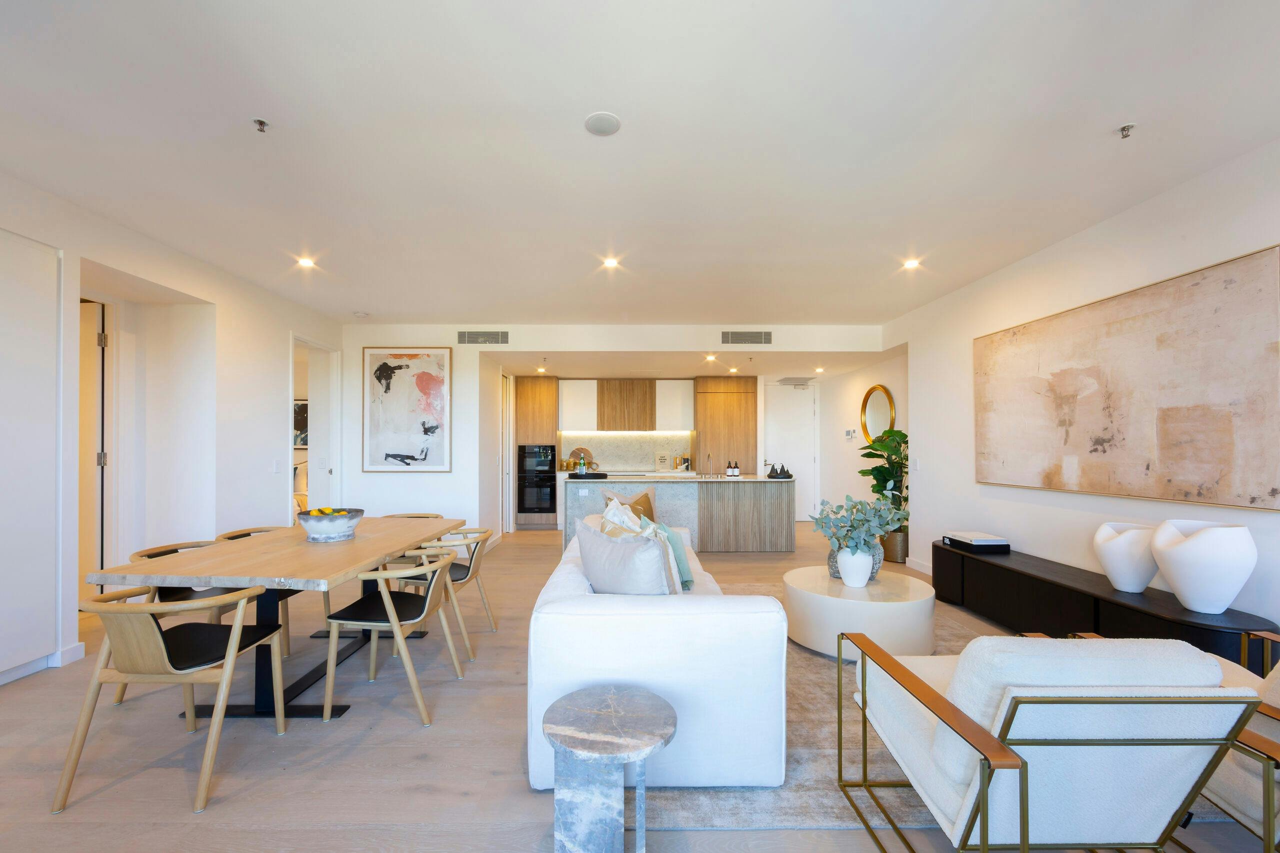 Open-plan apartment interior highlighting a spacious living room and adjacent kitchen area.