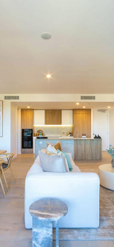 Open-plan apartment interior highlighting a spacious living room and adjacent kitchen area.