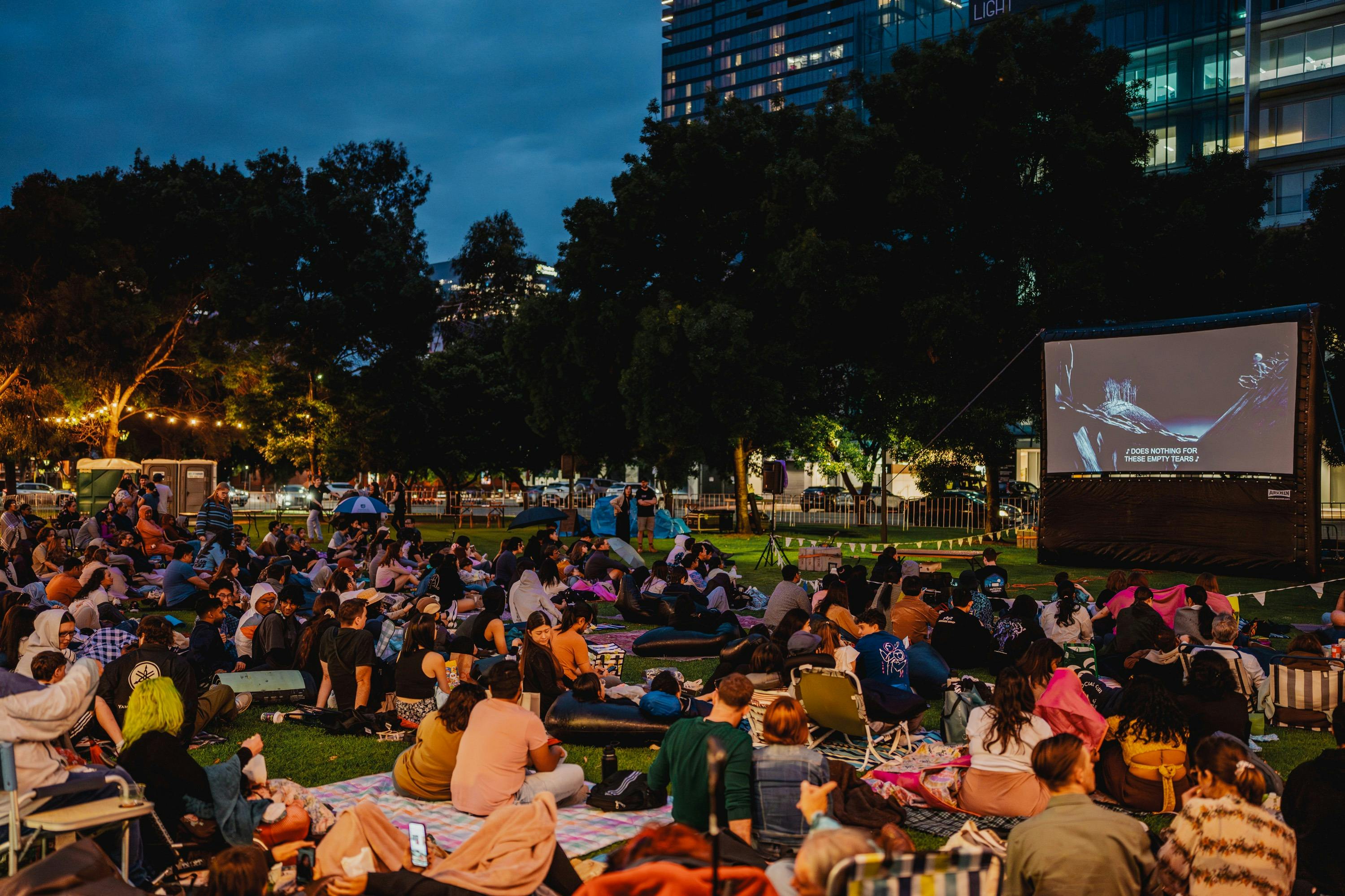 People at outdoor cinema at night