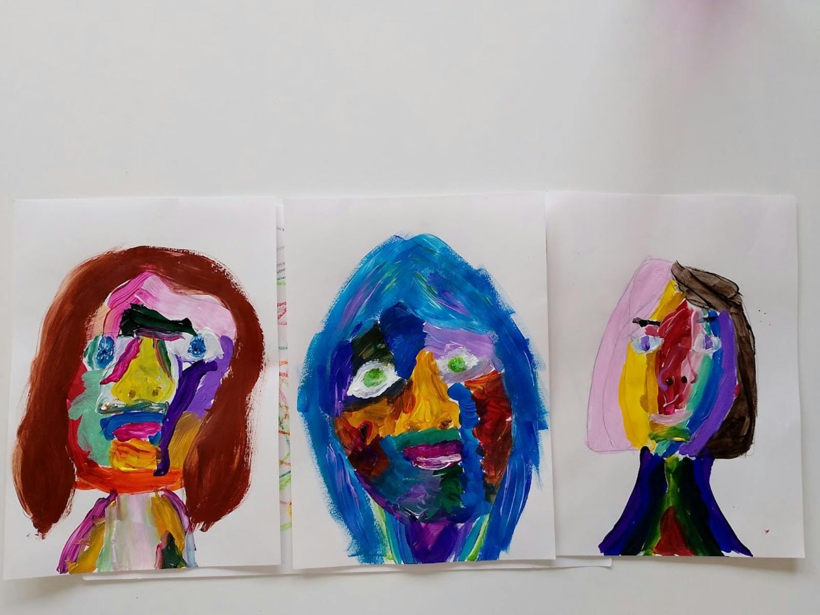 A painting of three colourful abstract faces