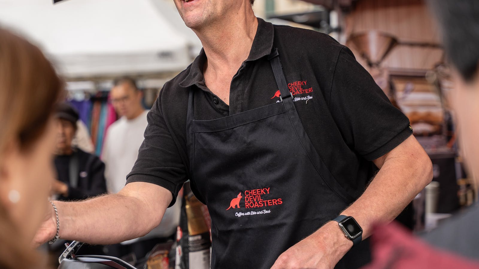 Serving freshly made coffee at the Cheeky Devil Salamanca Market stall.
