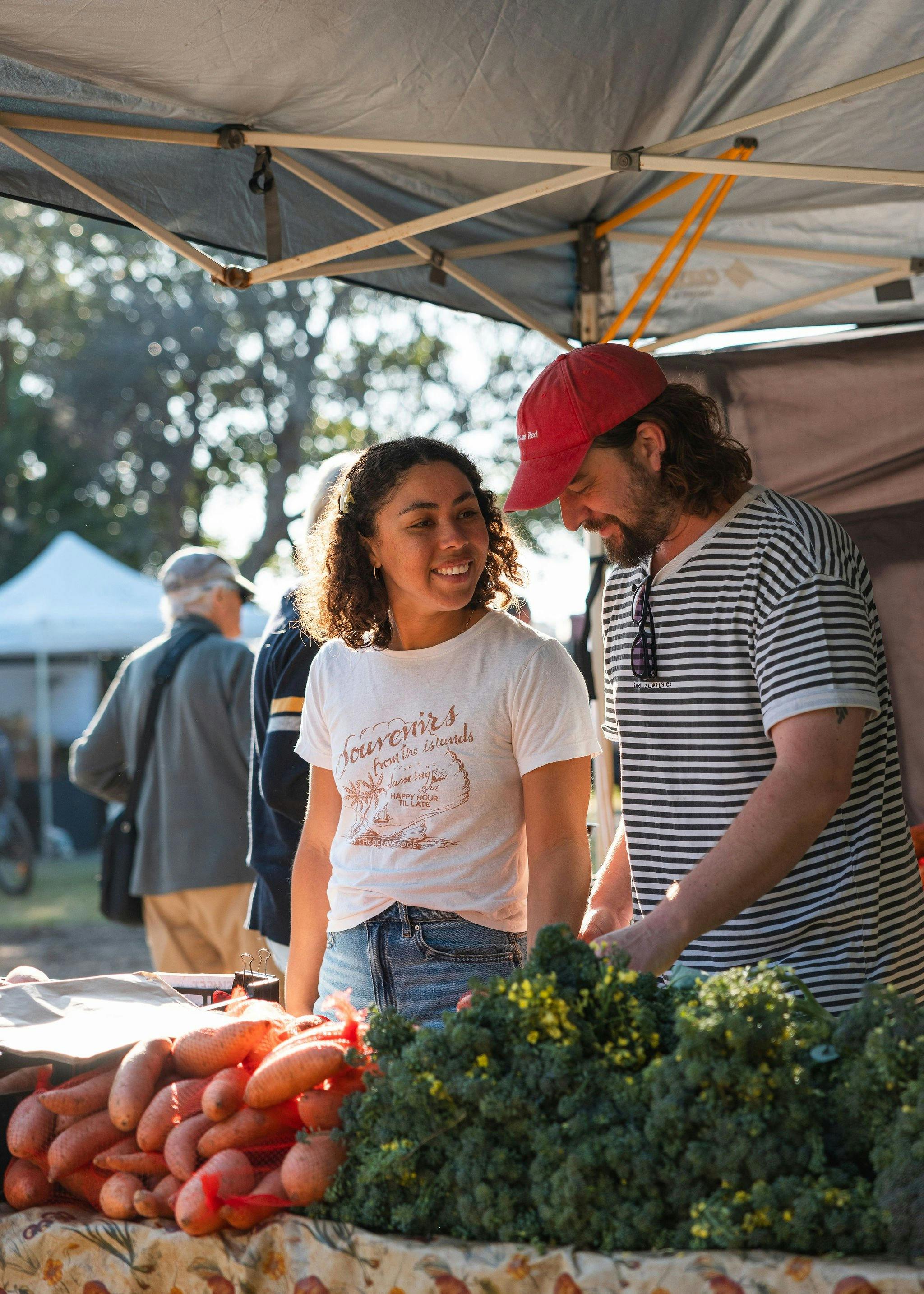 Image of a couple buying fresh fruit and vegetables from a stall