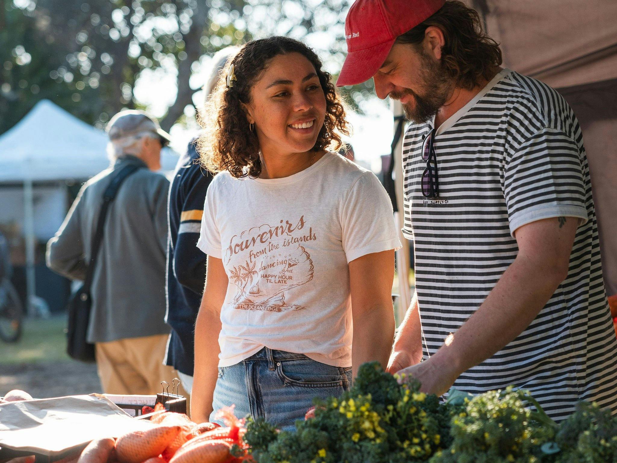 Image of a couple buying fresh fruit and vegetables from a stall
