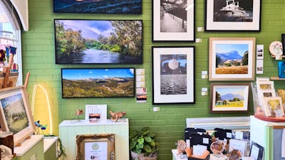 Photographs and oil colour paintings hung on a wall