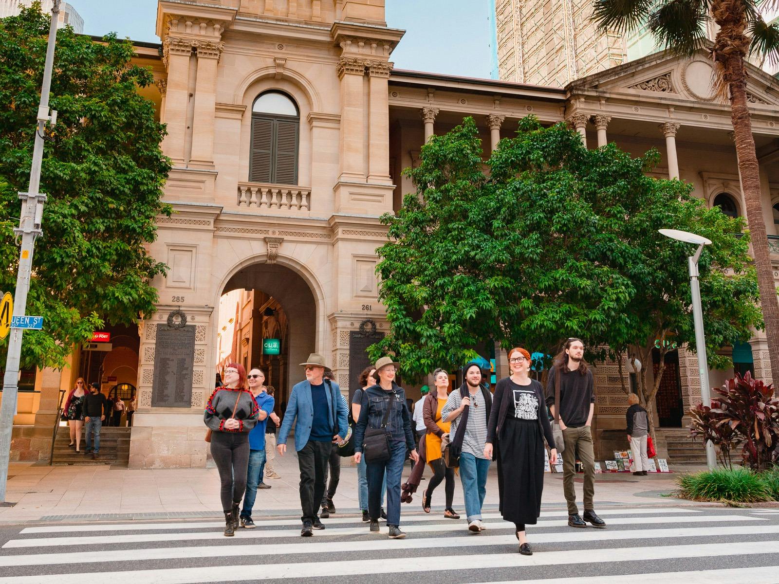 Group of people on a walking tour crossing the road.
