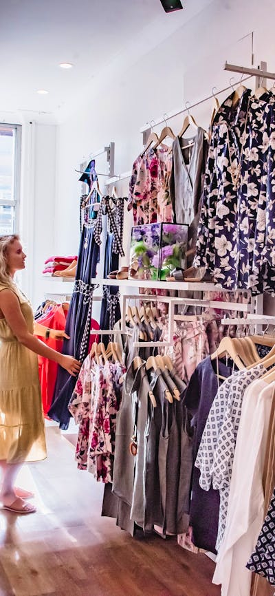 A woman looking at the women's clothes on display
