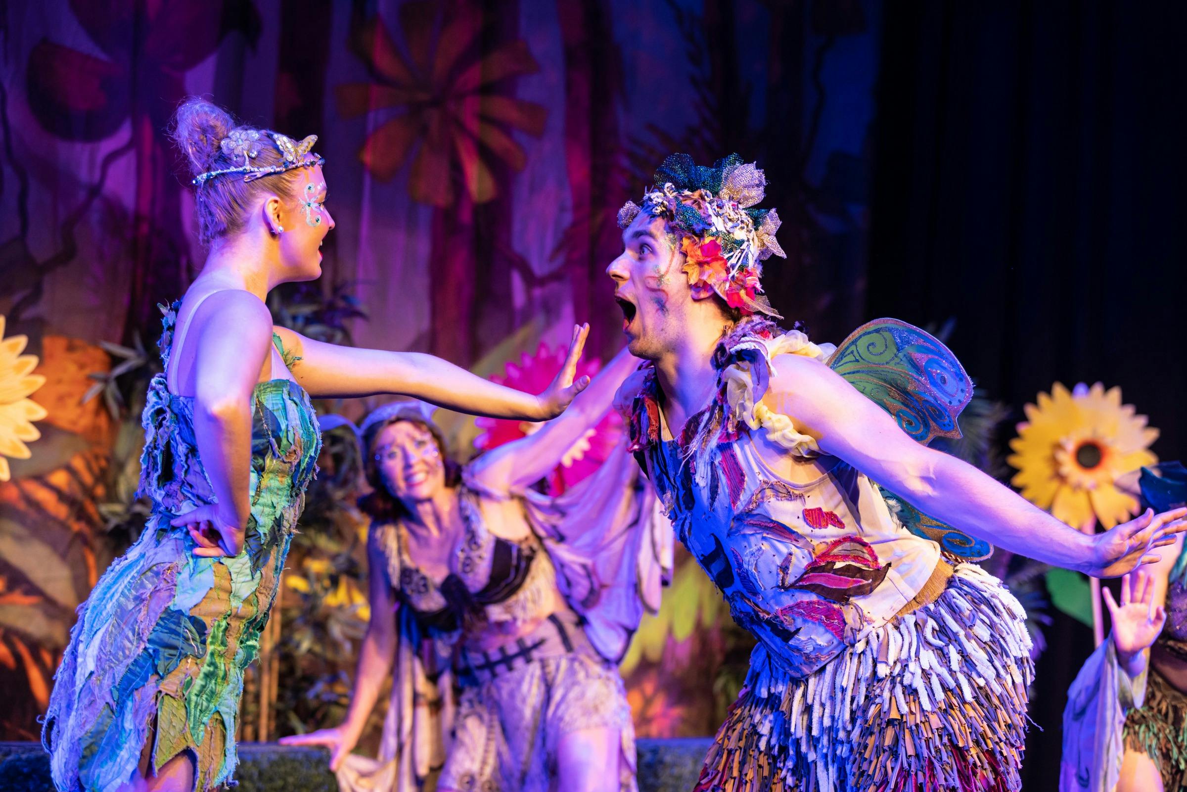 Two fairies greet each other on stage.