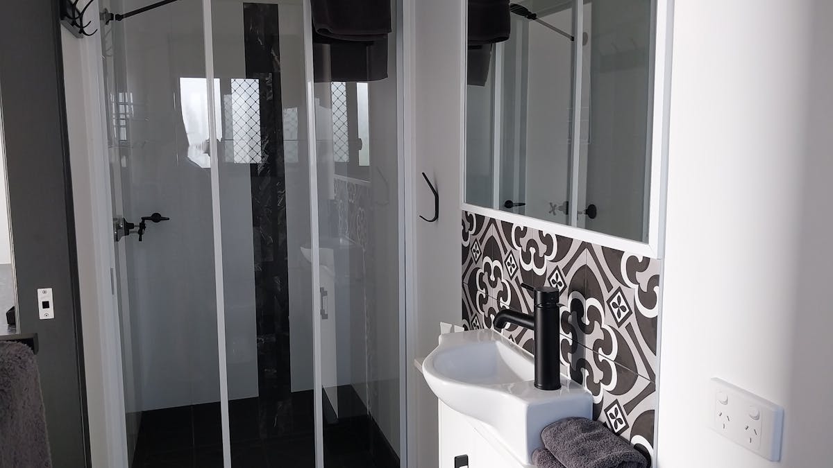 Modern private ensuite with shower, basin and toilet