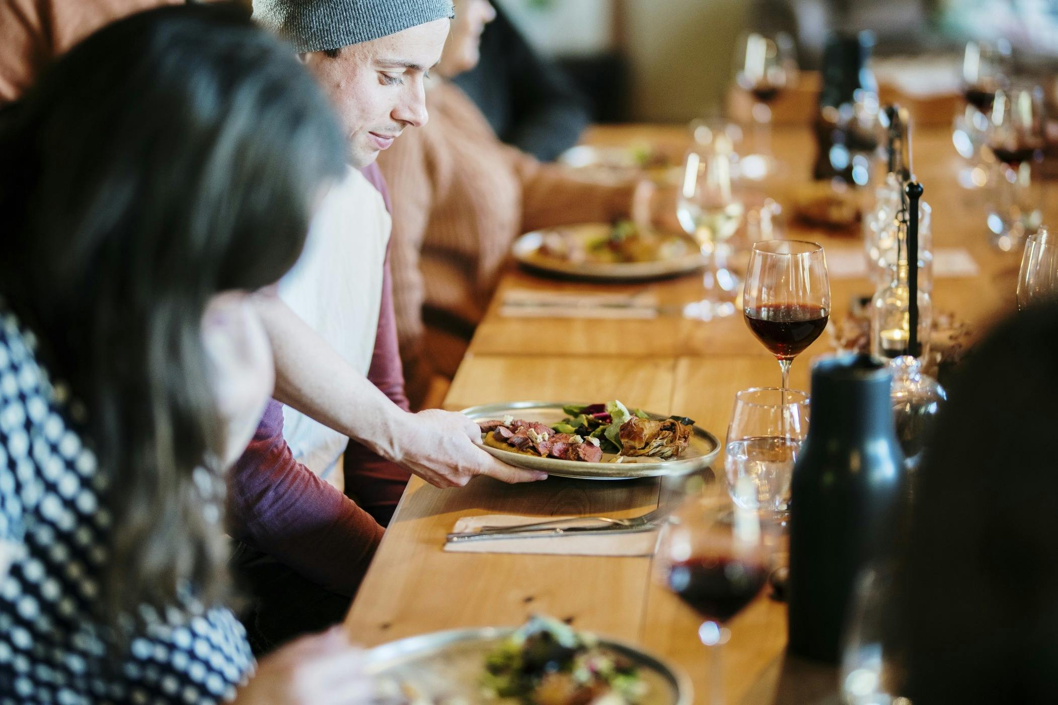 Guests enjoying lunch along a long table