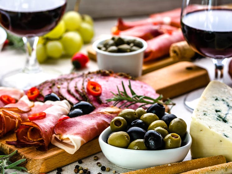 Meats and olives presented on cutting boards