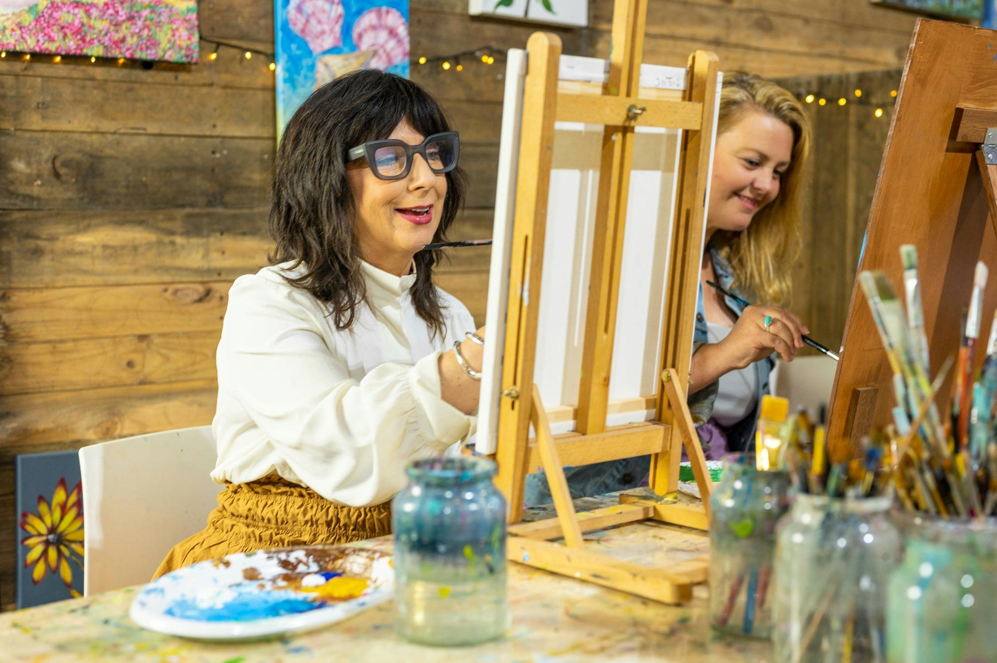Women undertaking a painting workshop