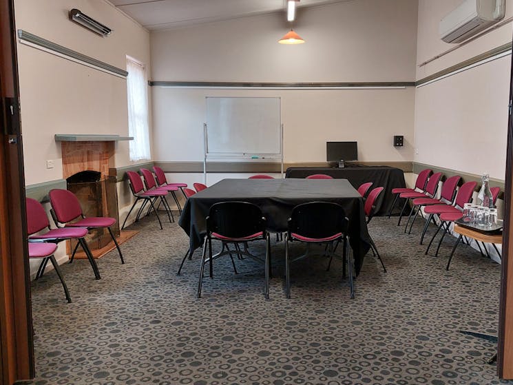 Supper Room with tables, chairs, whiteboard, monitor, aircon