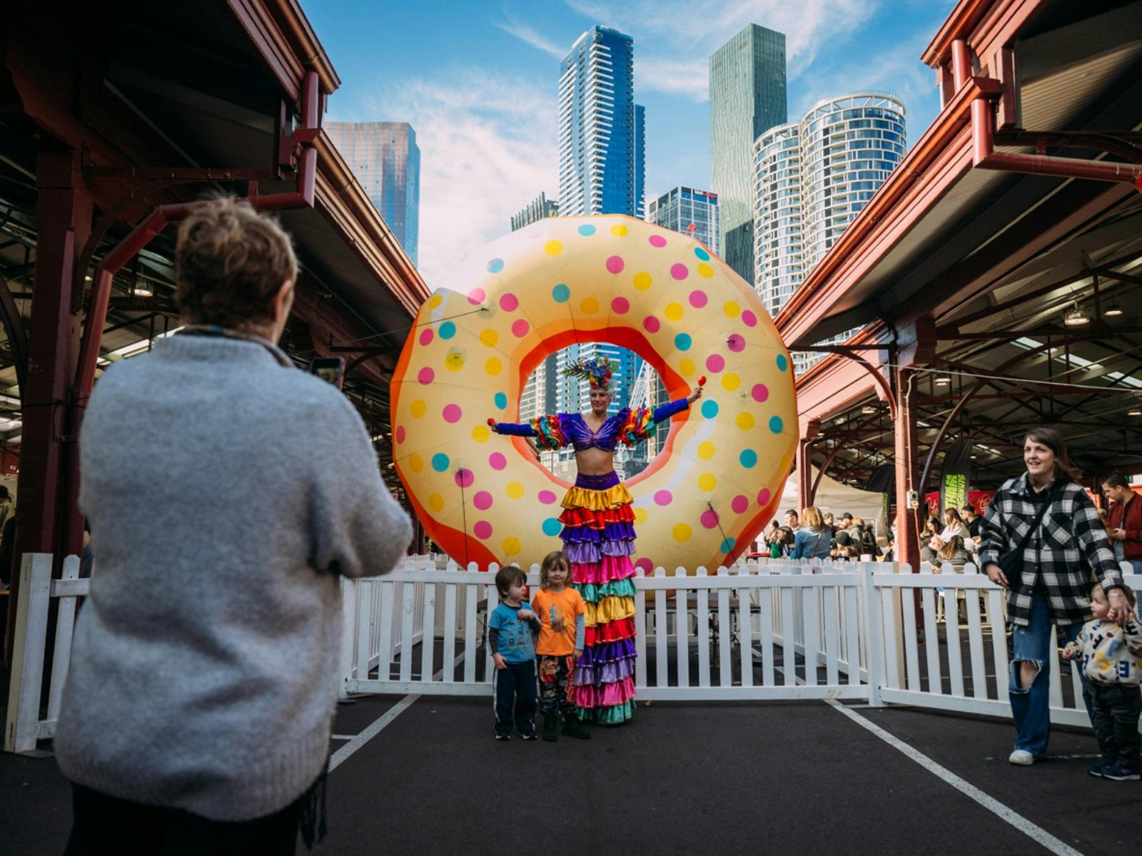 Performer in front of giant donut