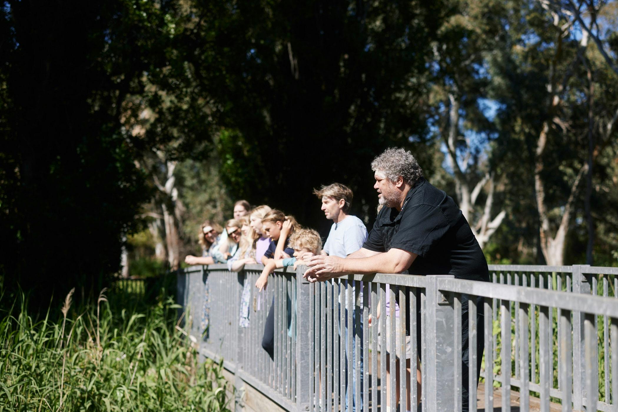 Customers overlooking Warriparinga river on bridge