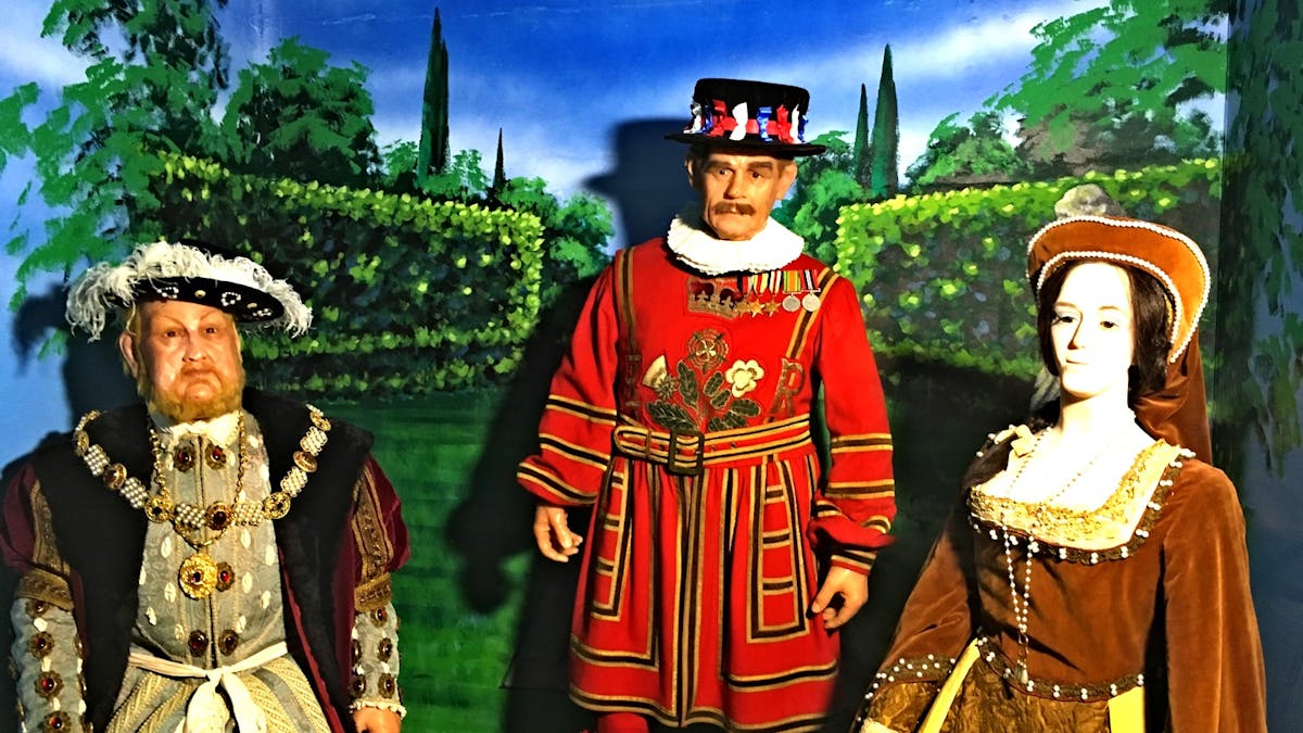 King Henry the eighth and Anne Boleyn and a Beefeater Gauardr