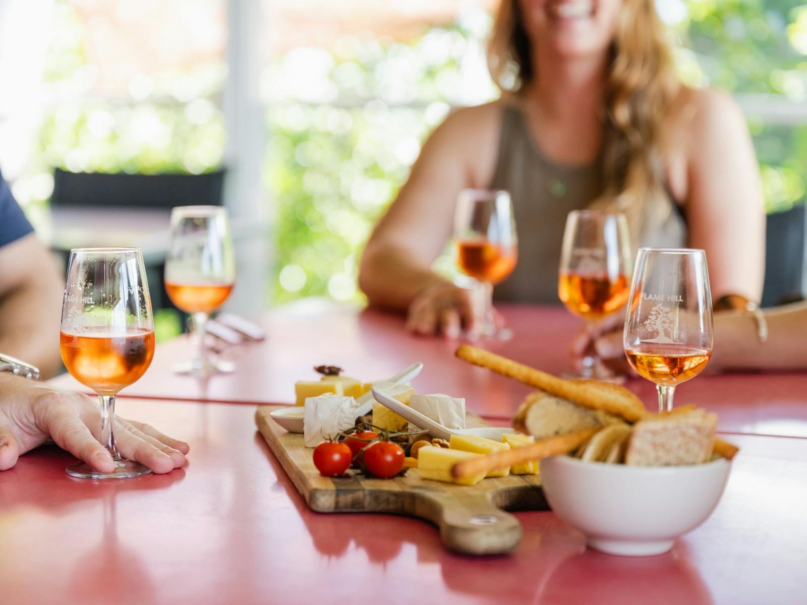 Glasses of wine surrounding a local cheese board
