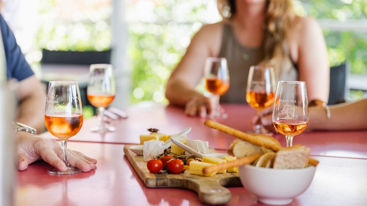 Glasses of wine surrounding a local cheese board