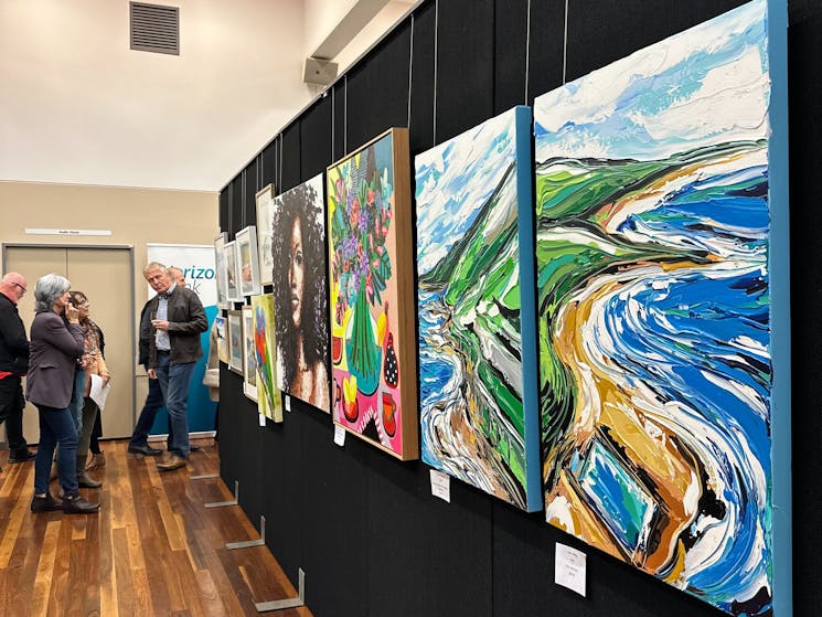A picture showing colourful artwork at the art show opening night 2023.