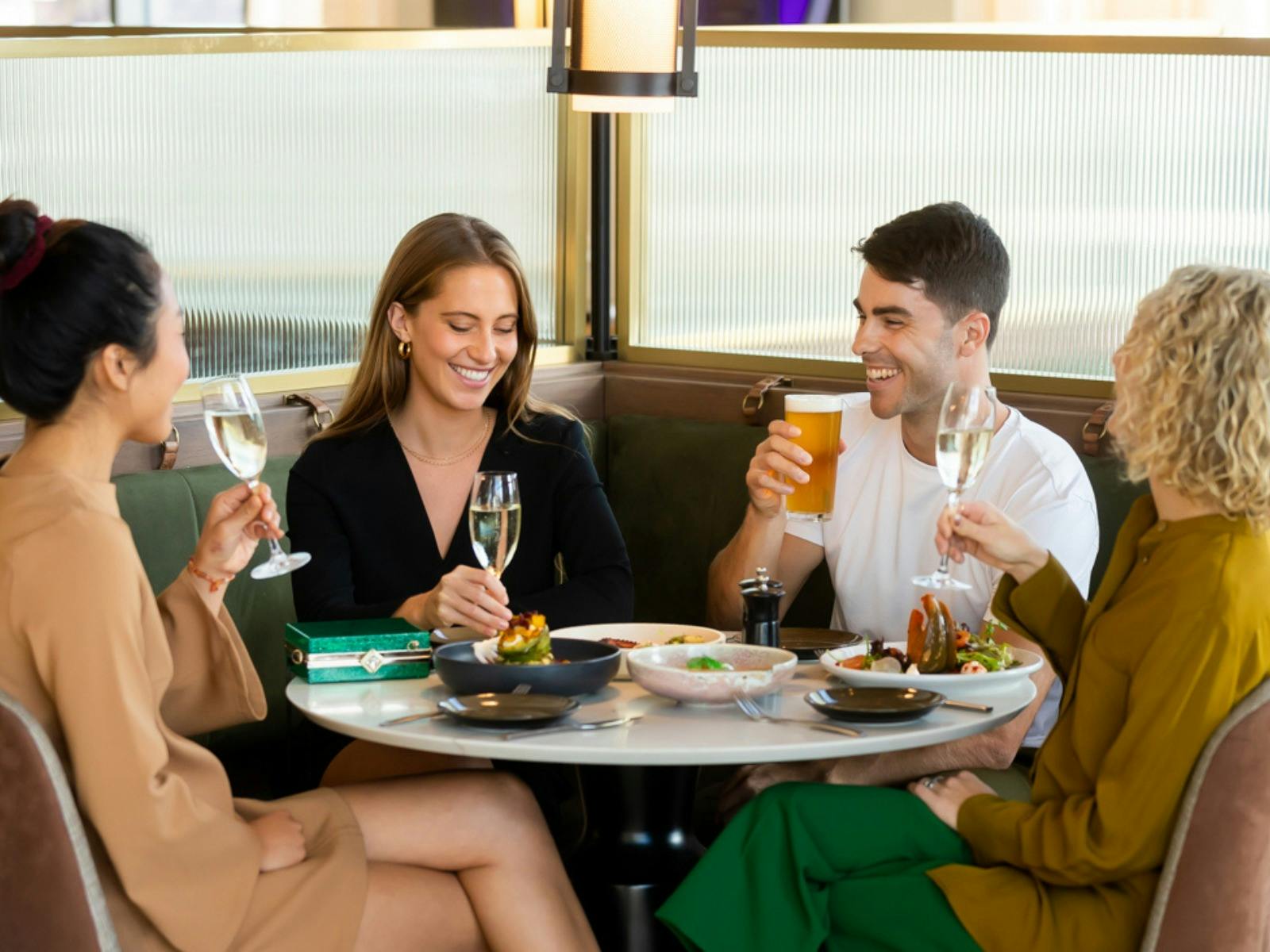 People sitting around table, eating and drinking