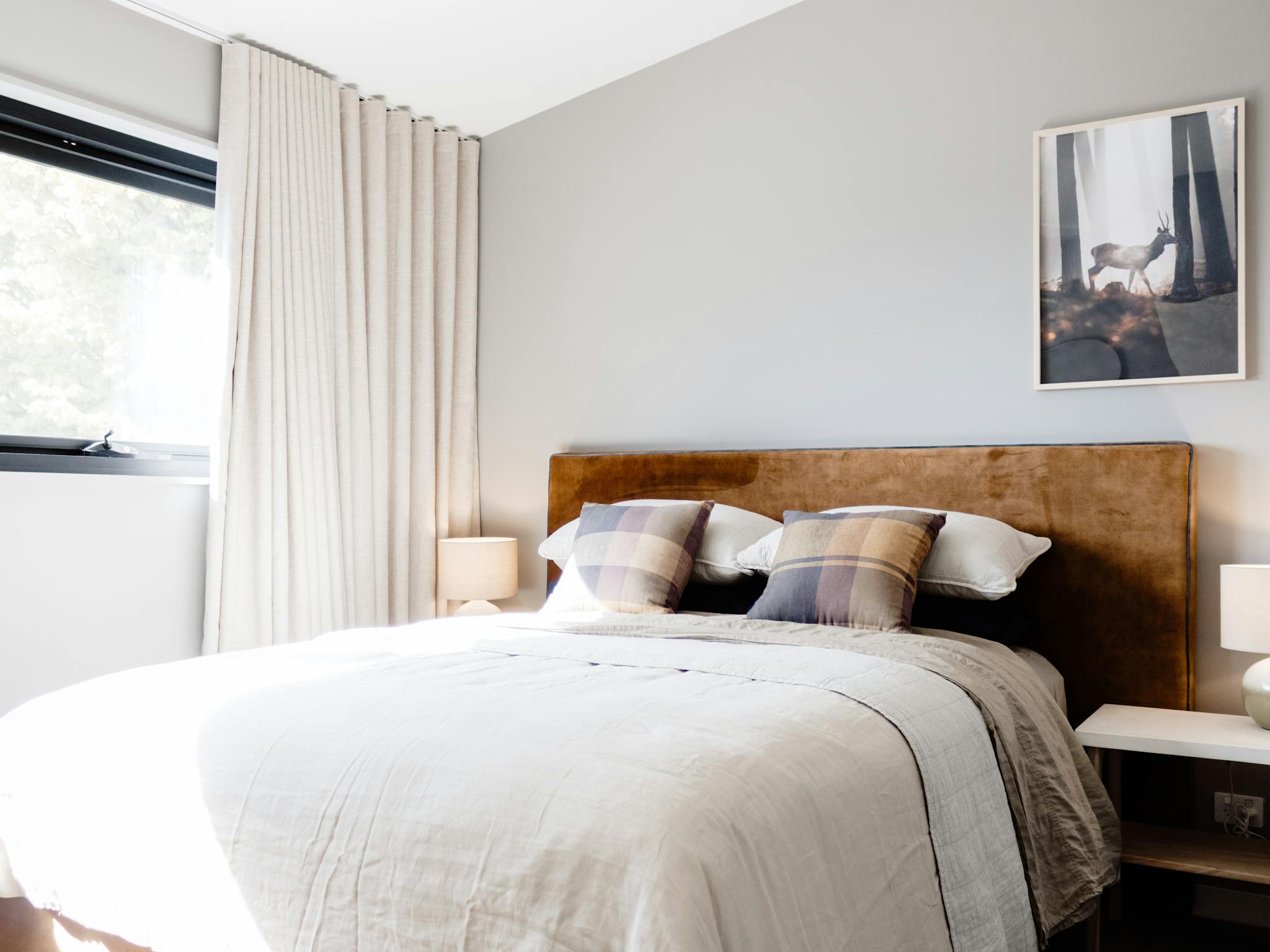 Roam Merrijig queen bed with caramel velvet bedhead, warm grey walls, artwork and european linens