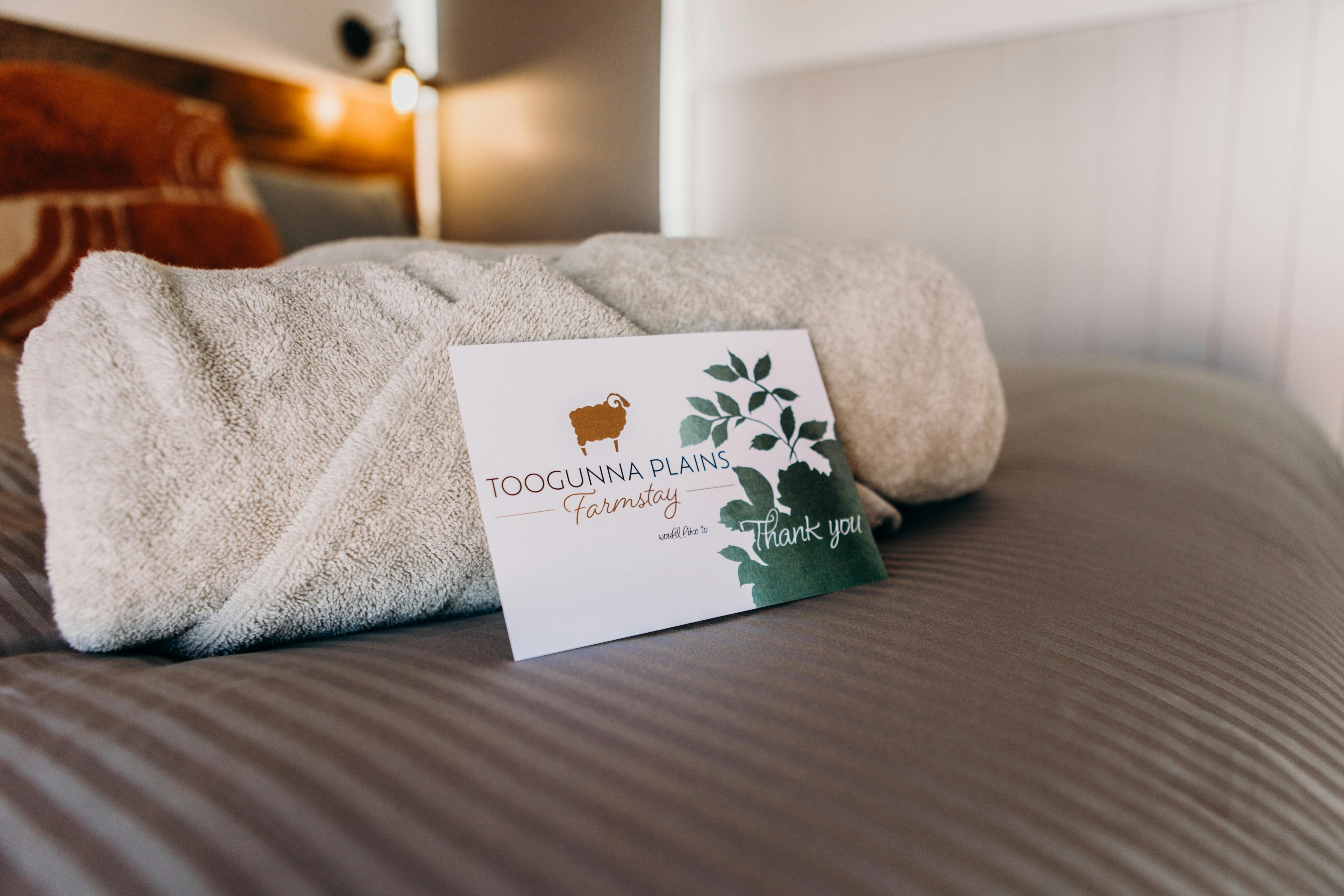 View of bed and welcome card