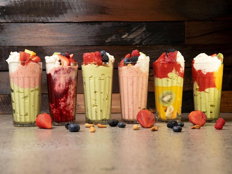 an Image of 6 glasses with fruit cocktails in them