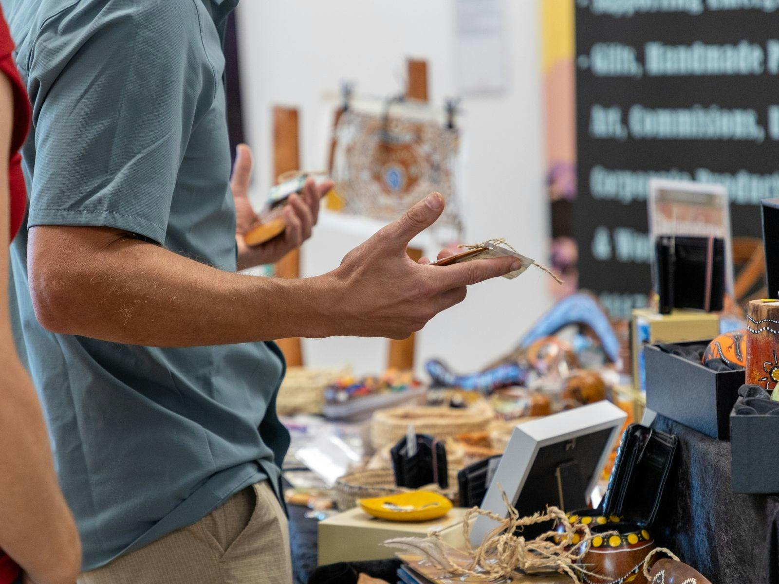 Shopper selecting arts and crafts at the markets