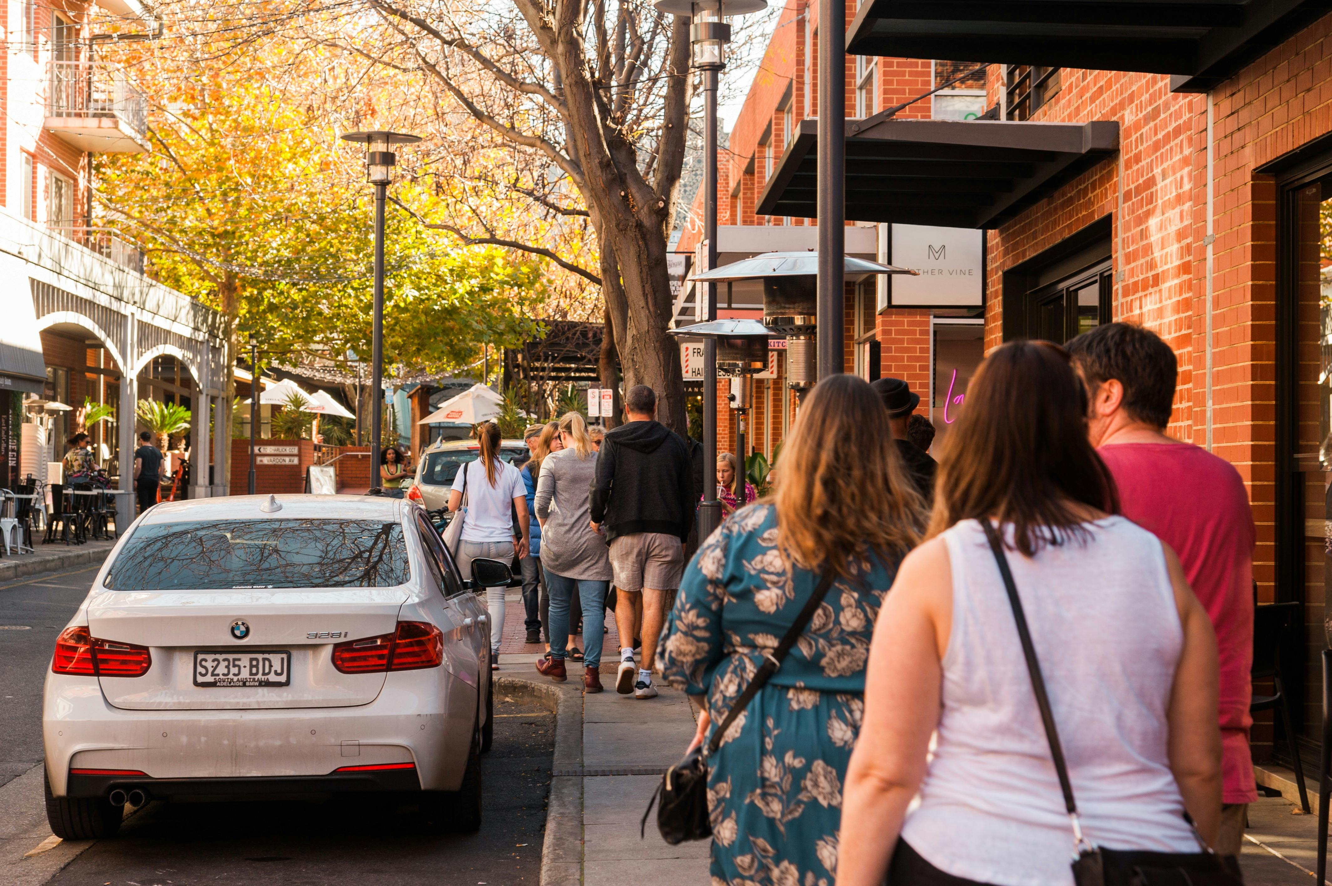 A tour group walks through Adelaide's East End area.