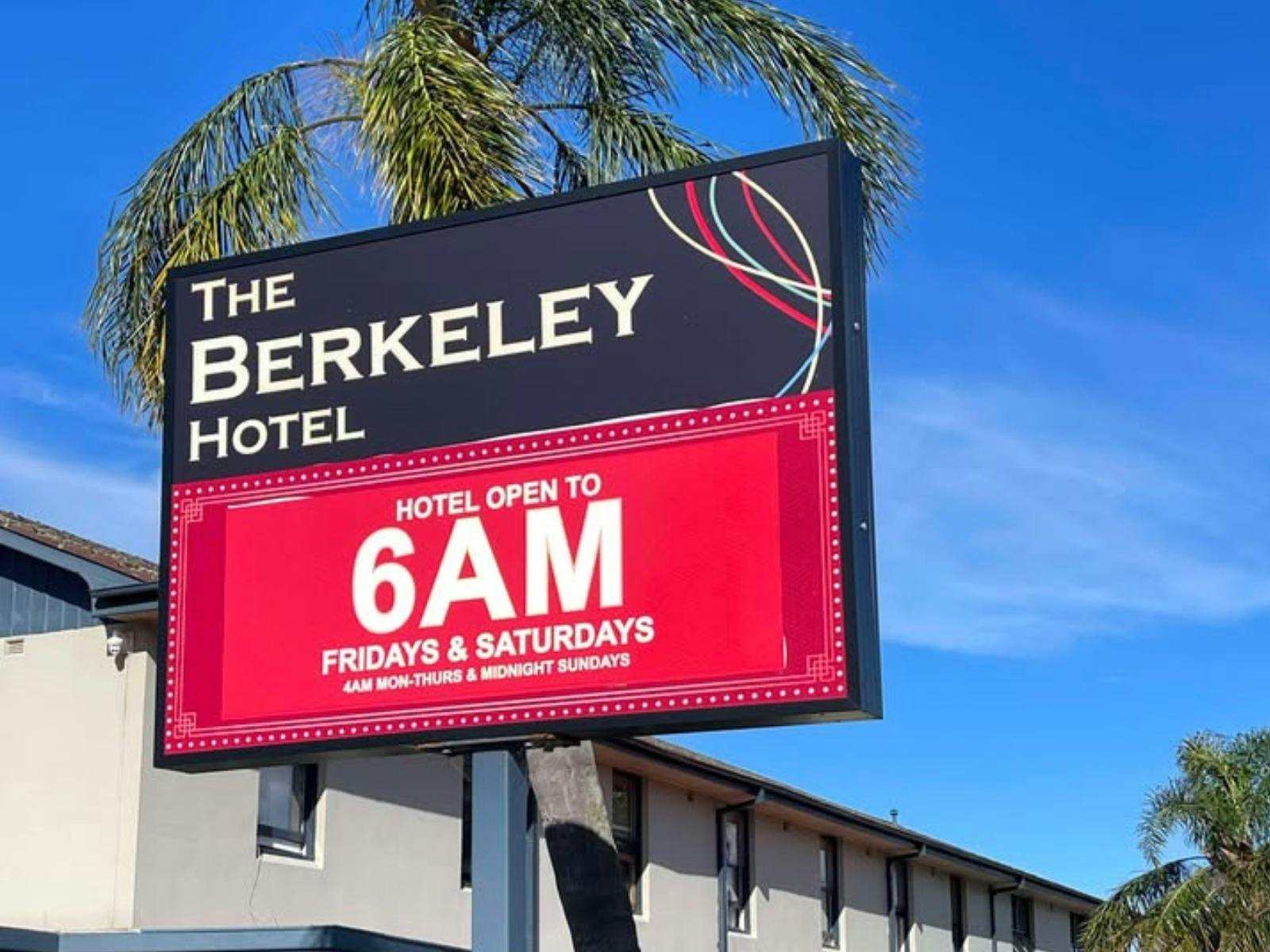 sign out the fron tof Berkeley Hotel with palm tree behind it