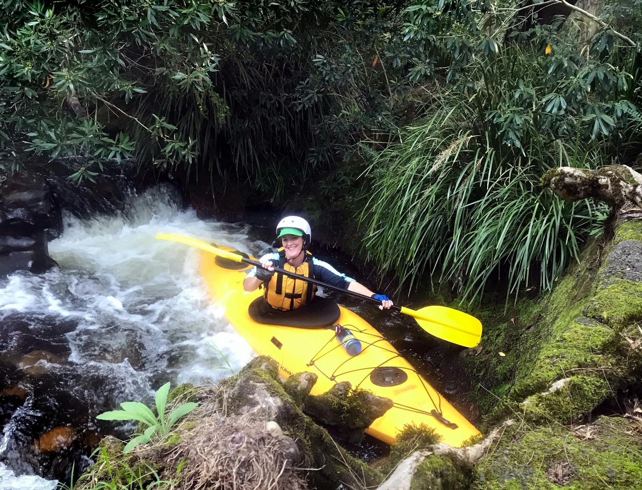 A person is sitting in a Kayak at the bottom of some whitewater on the Barrington River