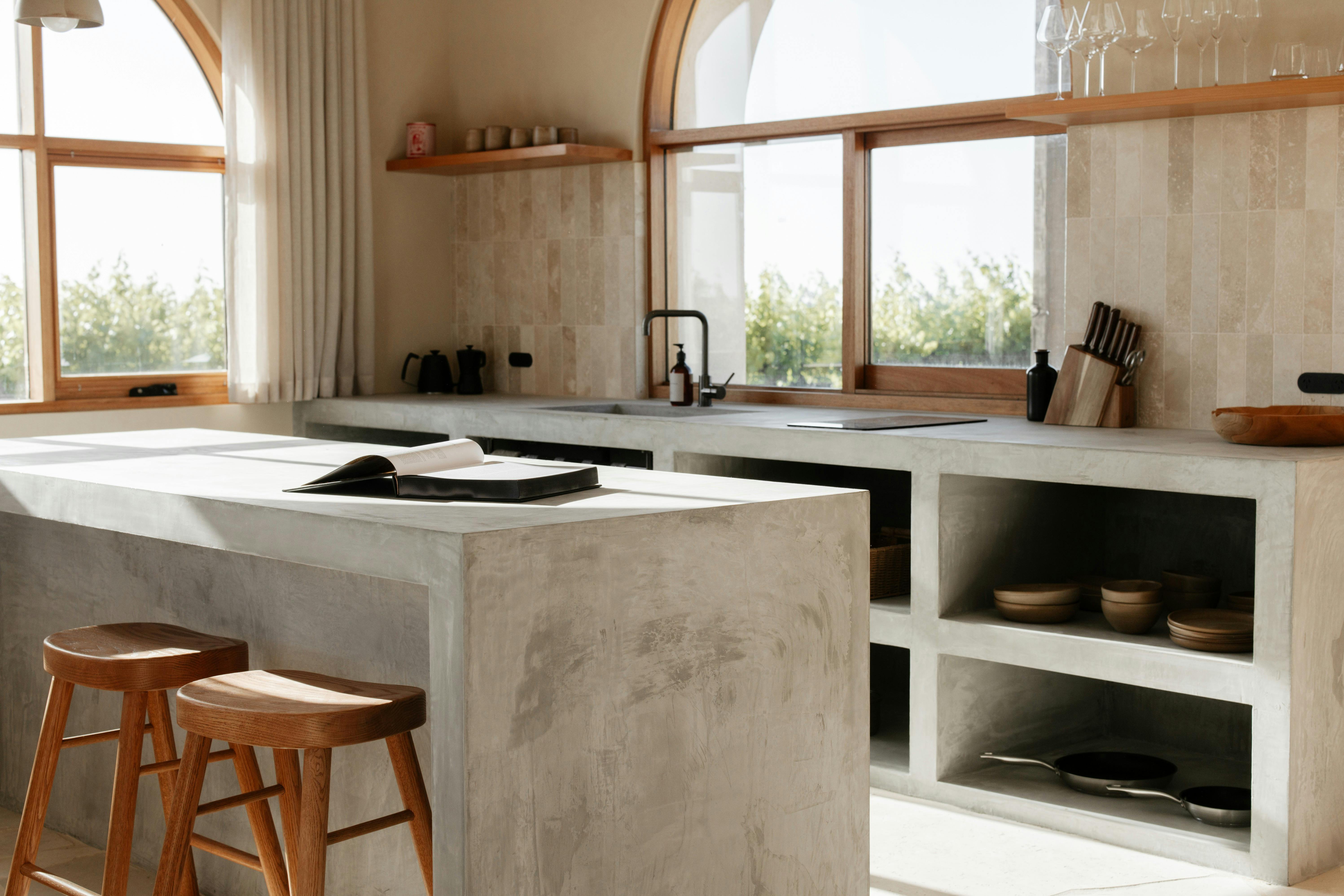 Stone ~ open plan kitchen with JamFactory ceramic tableware and custom stools.