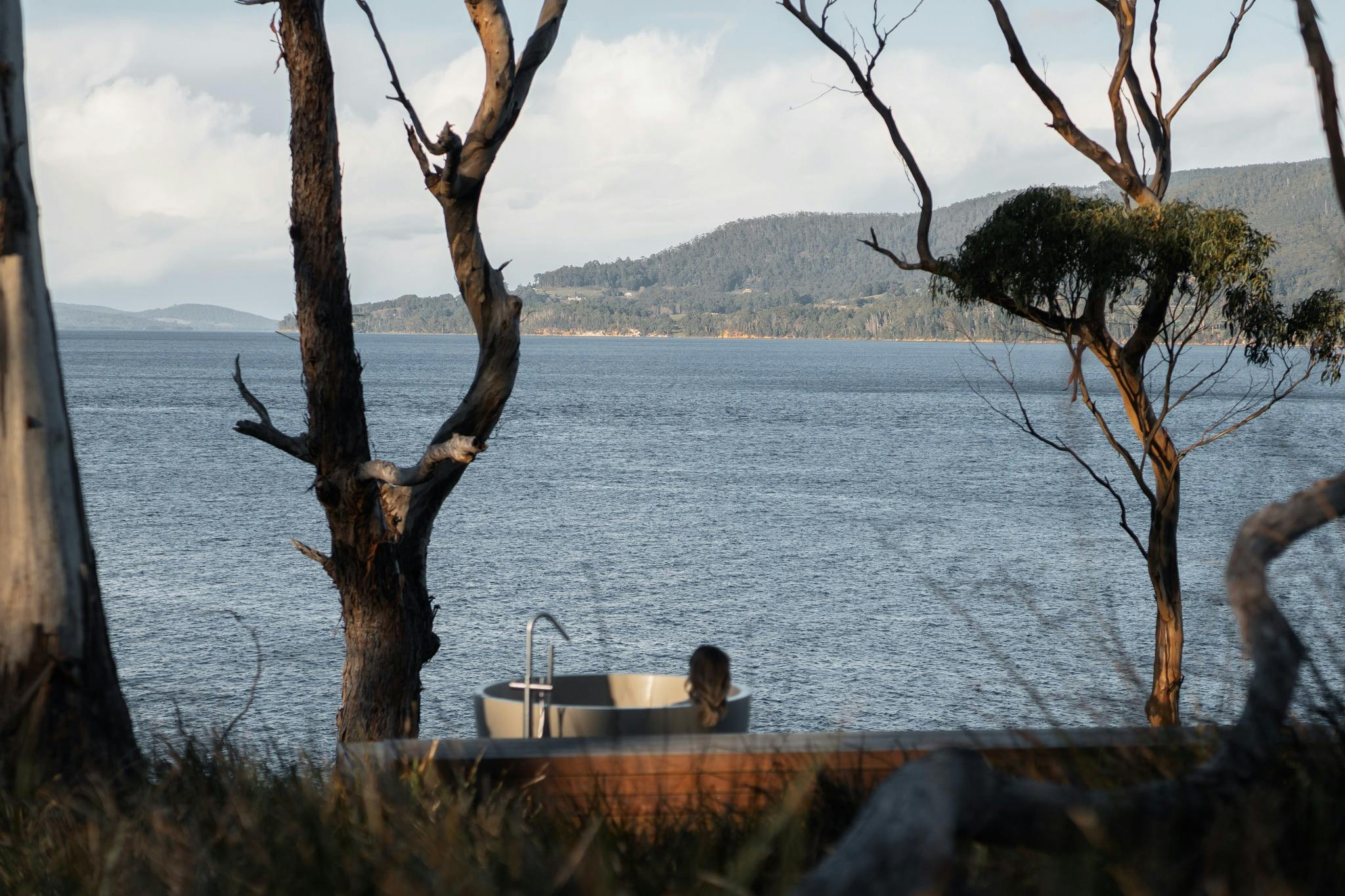 a woman in the bath overlooking the water