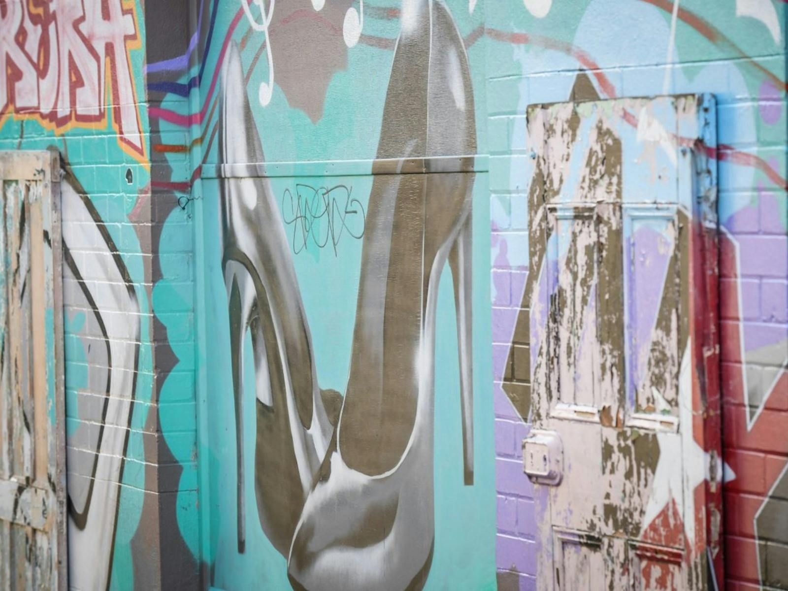 Shoes and colour paintings on wall