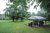 Walker and bike sitting in shelter shed in picnic area.