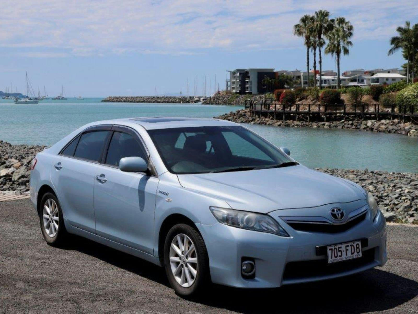 Heart of Reef Car for rent in front of Airlie Beach Background