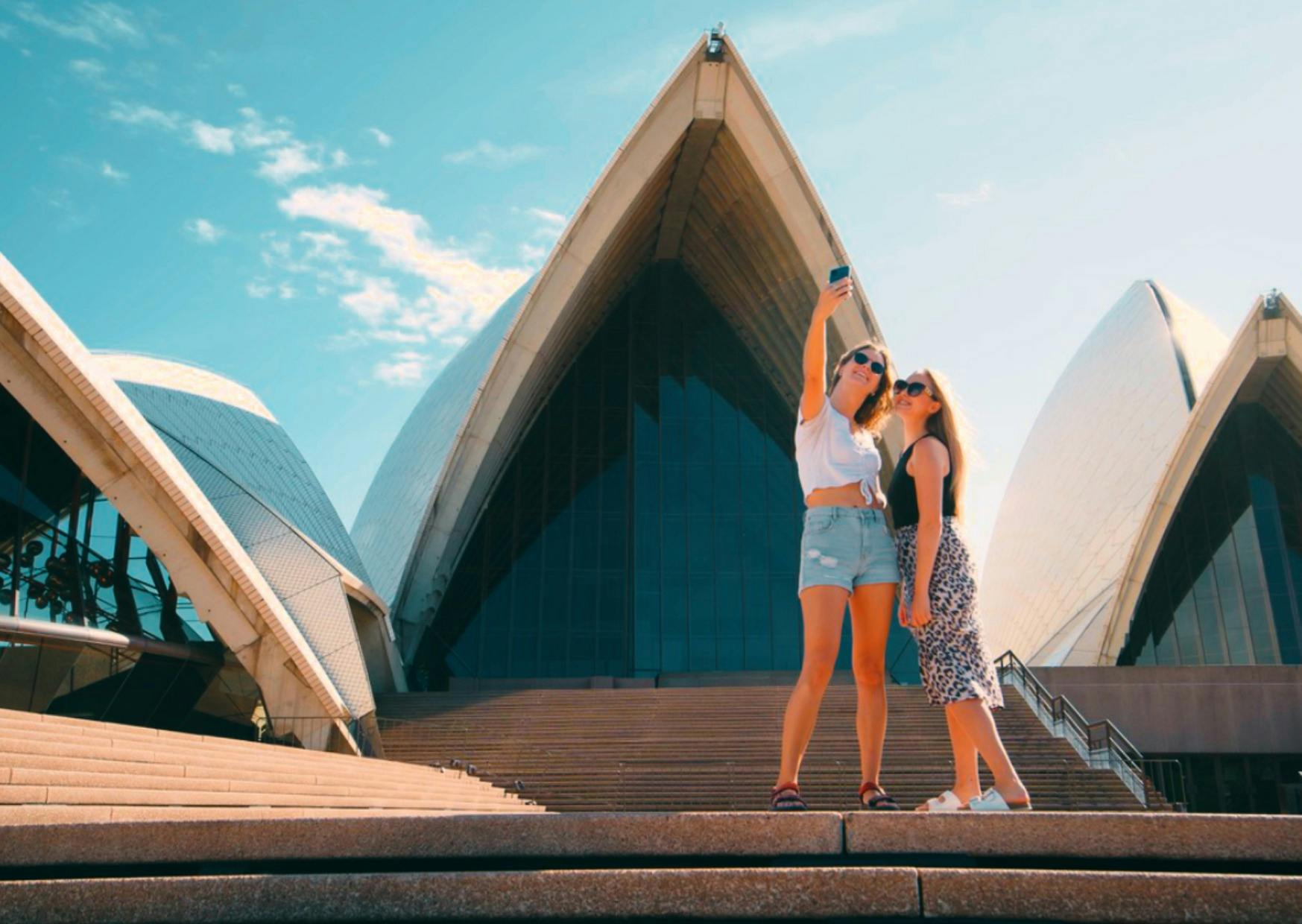 Two girls taking a selfie in front of the Sydney Opera House