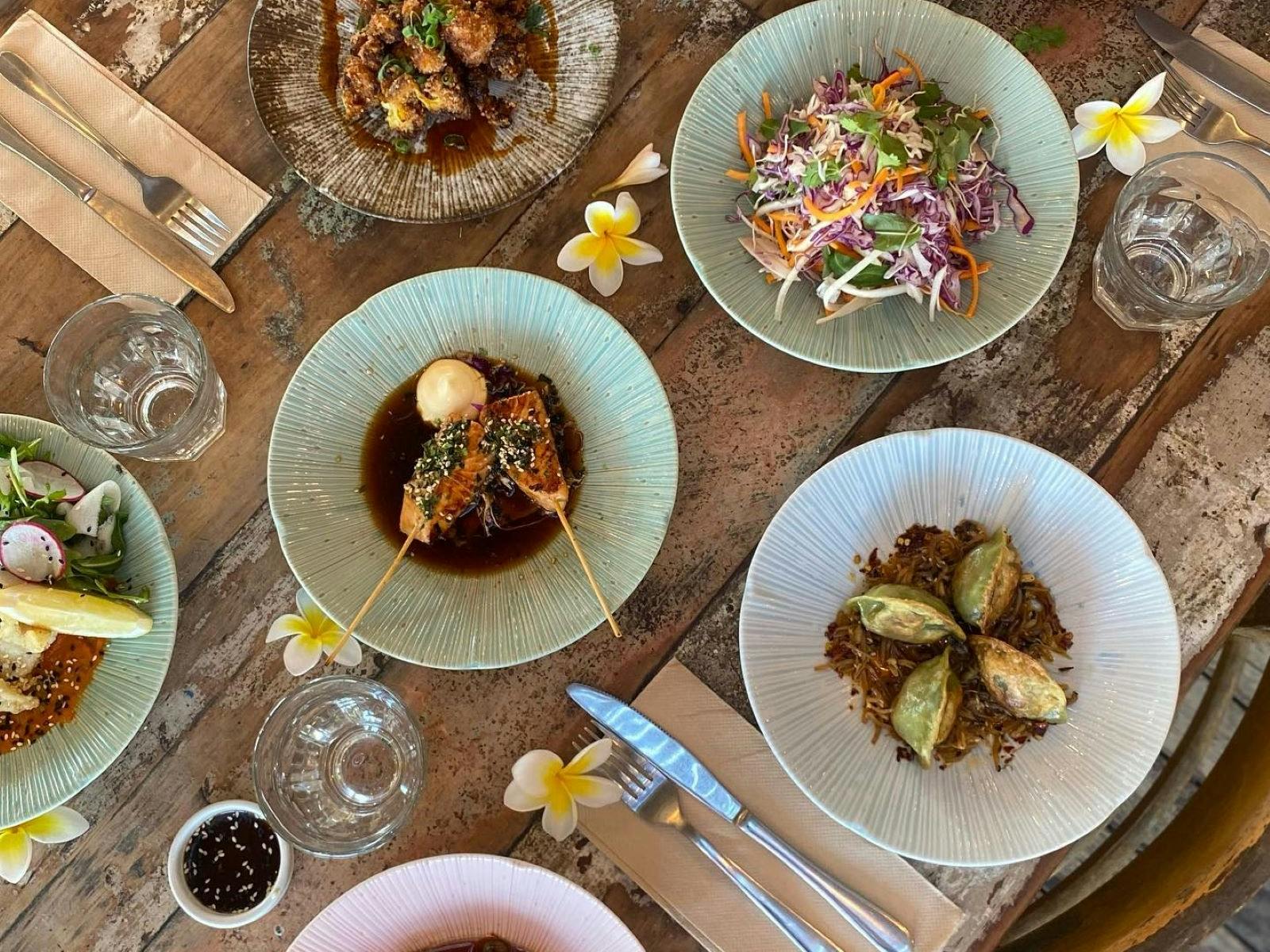 Various plates of food spread out on a table