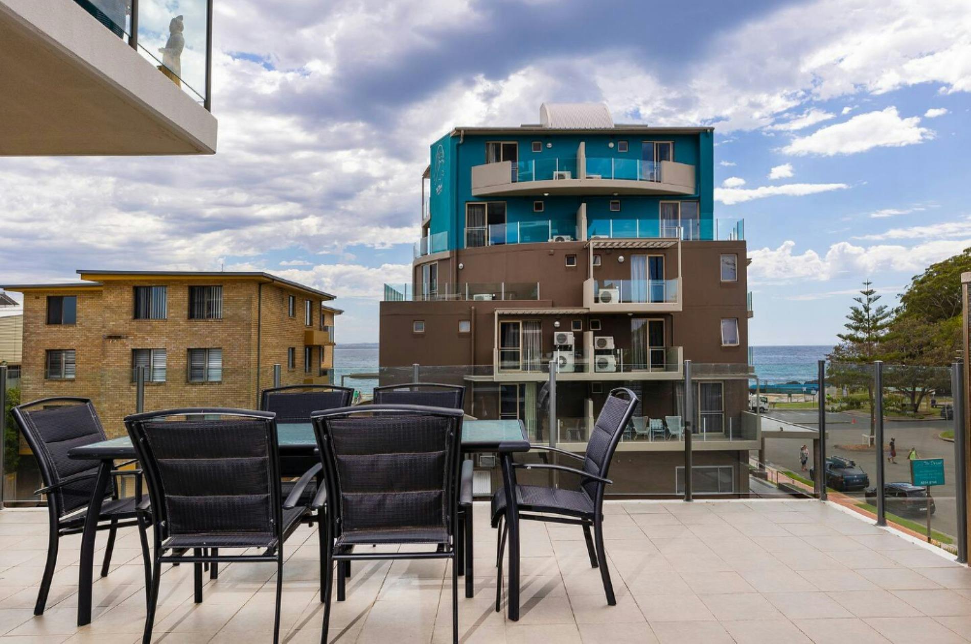 Balcony with ocean glimpses and dining setting