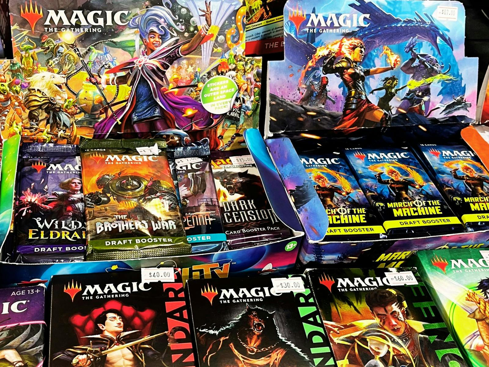 Booster packs of Magic the Gathering cards on display at vendor table