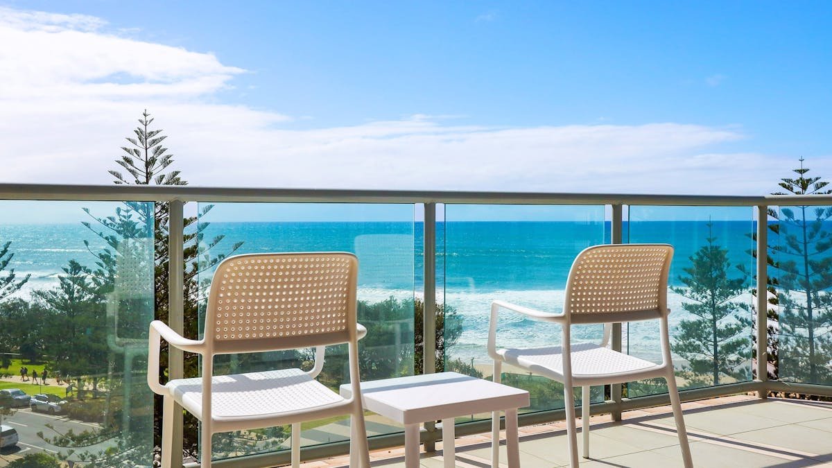 Beautiful ocean views from the balcony with outdoor chairs Peninsula Apartments in Surfers Paradise