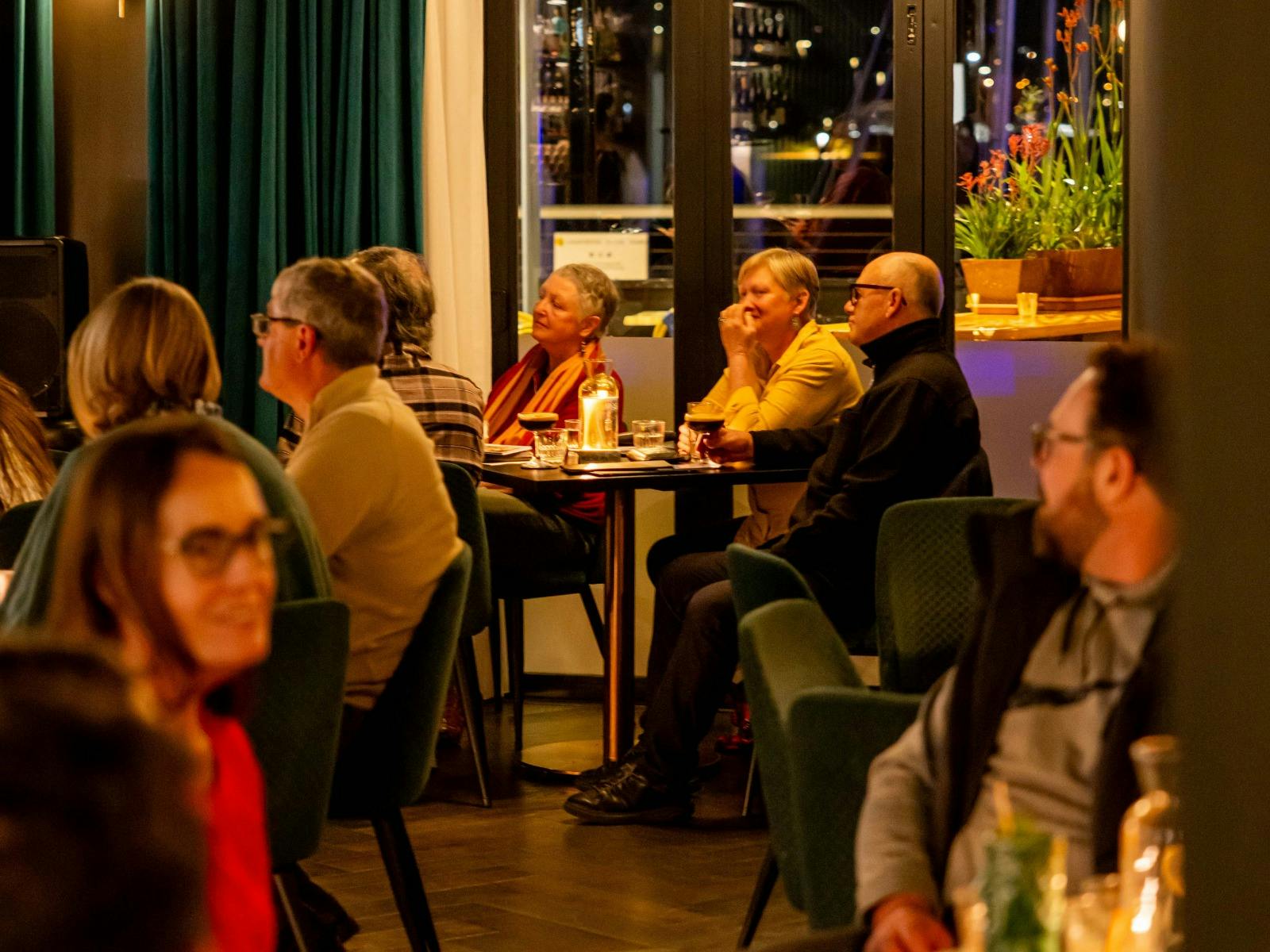 Patrons at bar urbane watching live music